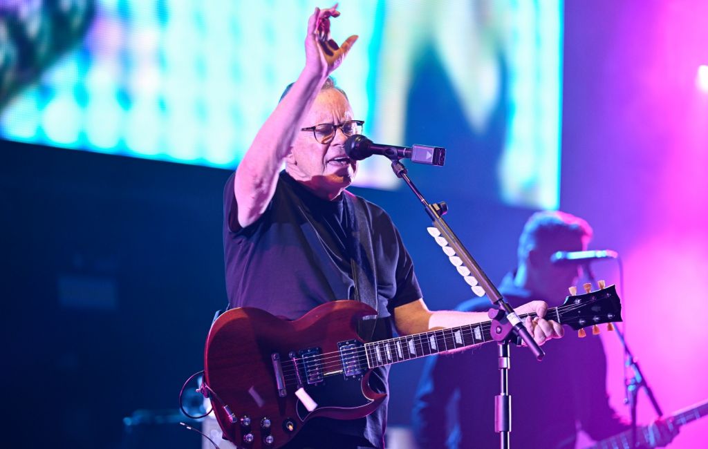 Bernard Sumner performing live on stage with New Order