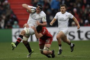 Ulster's James McNabney rides a tackle during his team’s December 2024 European Champions Cup match against Toulouse