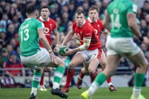 Wales' Nick Tompmins prepares to pass the ball in his team's February 2024 Six Nations match against Ireland.