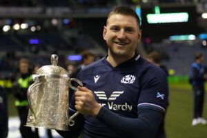 Scotland's fly-half Finn Russell celebrates with the Calcutta Cup after the Six Nations international rugby union match between Scotland and England at Murrayfield Stadium in Edinburgh