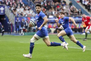 France's Romain Ntamack runs with the ball with support from Antoine Dupont during the 2023 Six Nations game against Wales