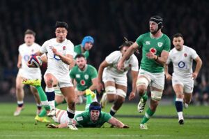 England’s Marcus Smith evades the attentions of Ireland’s Ryan Baird and Caelan Doris in the sides’ 2024 Six Nations encounter.