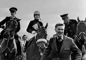 Ginger McCain leads in a victorious Red Rum