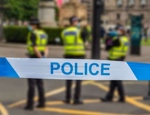 A picture of police behind a cordon, illustrating a story about a photographer who was turned down for a job as a call handler for Leicestershire Police over information "leakage" risks, which has alarmed some journalists including one former Telegraph desk manager who himself worked in a police station.