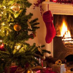 Christmas tree and stocking near fireplace