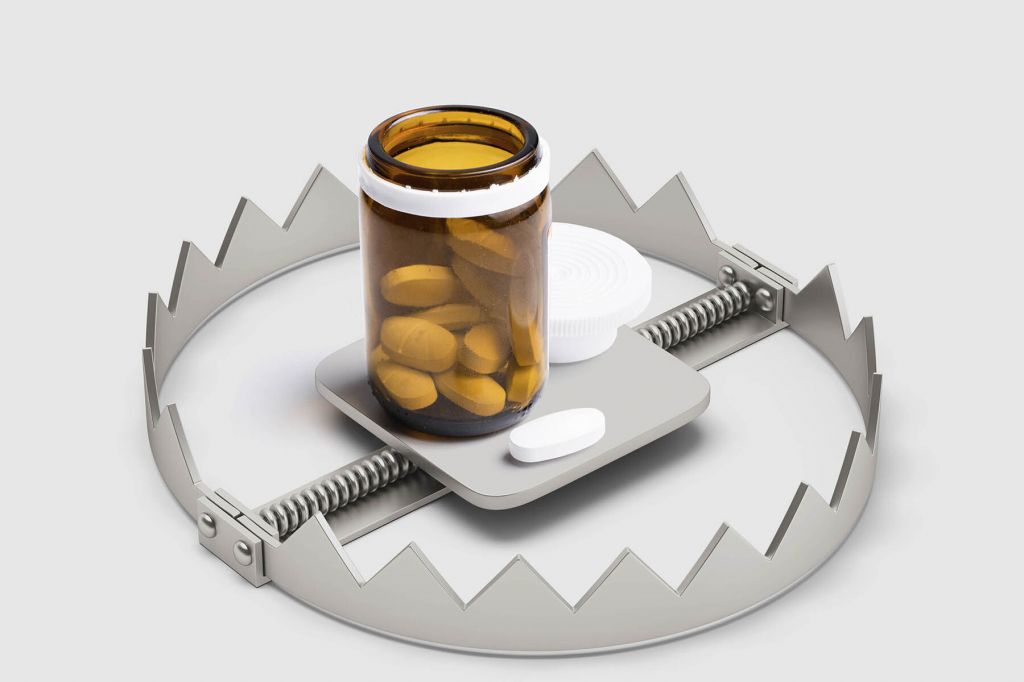 A photo illustration of a bear trap, with an orange bottle of tablets at its centre