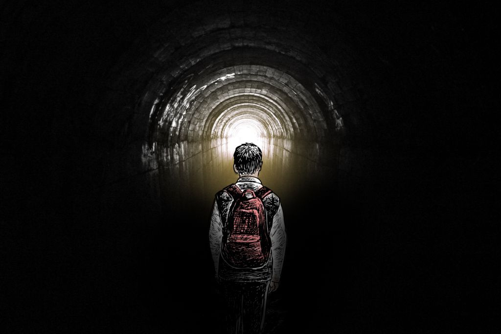 In a photo illustration, a young man wearing a backpack faces a long dark tunnel with only a small amount of light at the very end