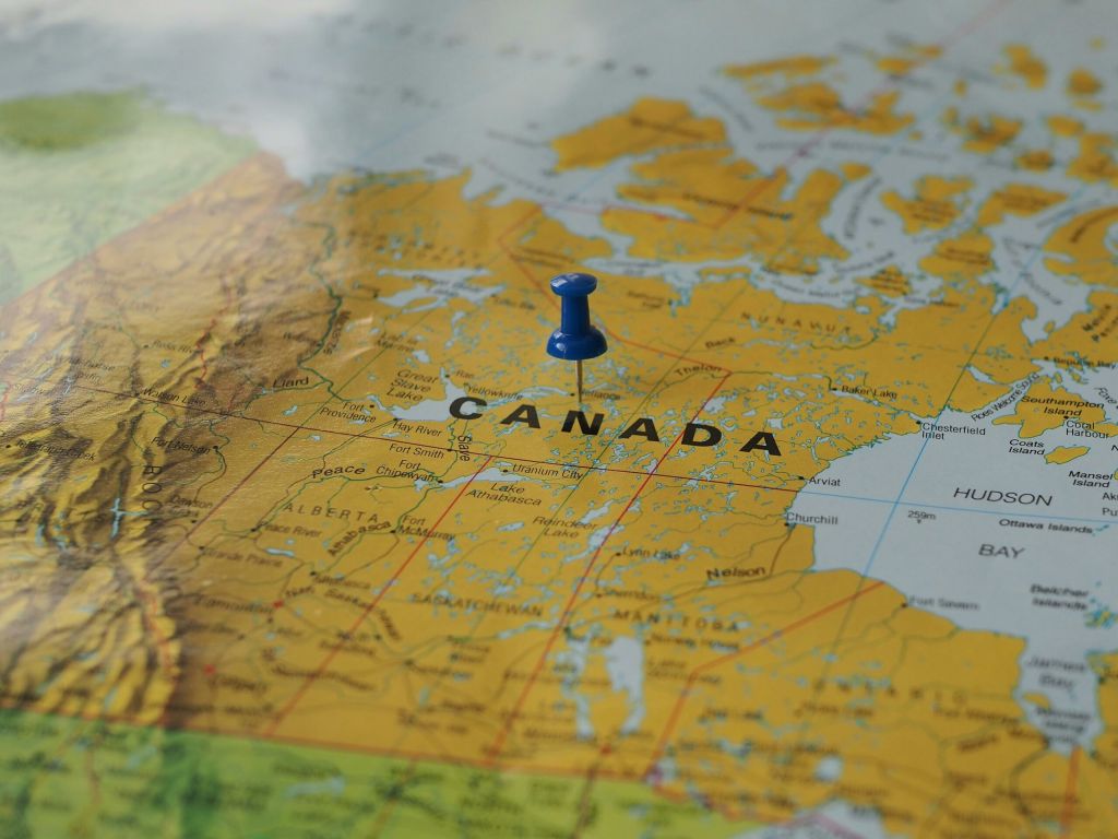 An image shows Canada on the map with a pin in it