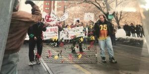 Protestors for housing carry the burned mattress where Bobby McLaughlin died, Dundas St. E, Toronto, 2003.