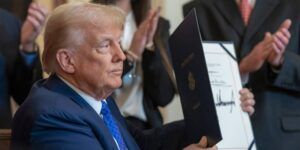 Donald Trump signing the Laken Riley Act, leading to harsher border restrictions.