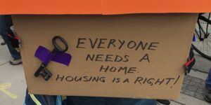 A sign advocating for the rights of the unhoused.