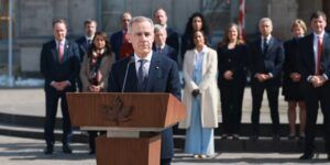 Carney speaking outside Rideau Hall in front of his cabinet.