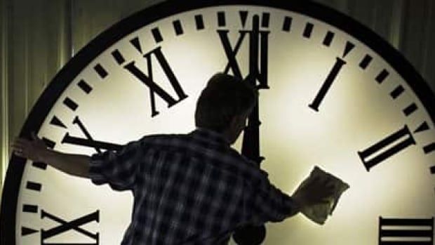 Man changing clock