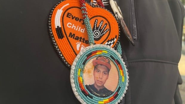 a beaded necklace with a picture of a person in it