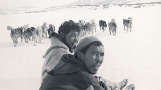 Two Inuit men on dog sled