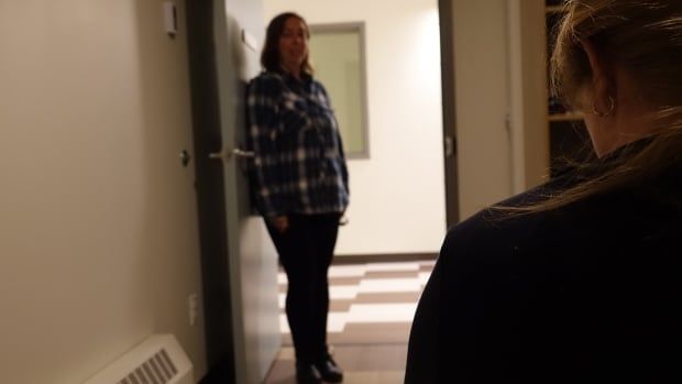 Survivor at an Ottawa shelter with a shelter worker looking on