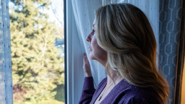 A person stares out a window.