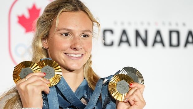 Toronto swimmer Summer McIntosh poses on Aug. 5, 2024 with her four medals earned at the Summer Olympics in Paris, France. 