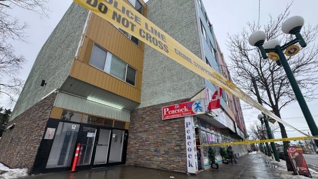 An apartment building surrounded by yellow Edmonton police tape