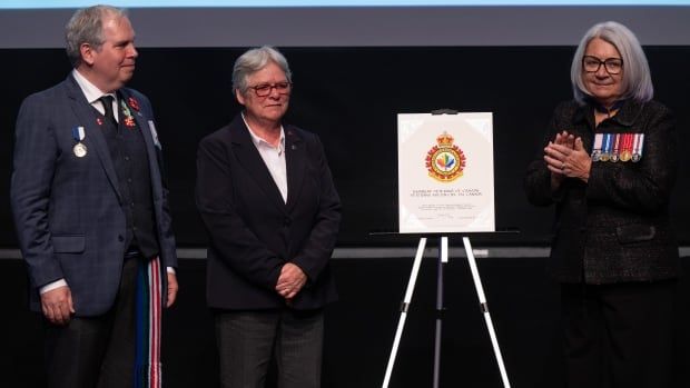 Governor General Mary Simon applauds founder and co-chair Diane Pitre and co-chair Todd Ross of Rainbow Veterans of Canada following the unveiling of a heraldic badge, Friday, April 19, 2024 at the Canadian War Museum in Ottawa. 