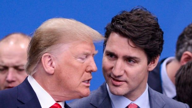 A pugnacious Donald Trump, his jaw thrust forward, talks to Justin Trudeau, whose head is tilted with a quizzical expression.