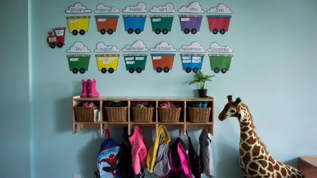 Cubby holes and backpacks hang on the wall of a daycare in Langley, B.C.