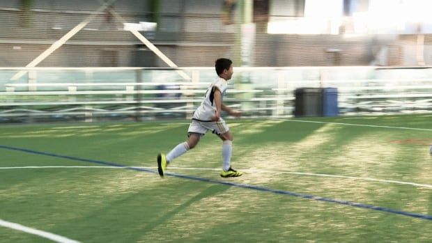 Boy running on indoor field