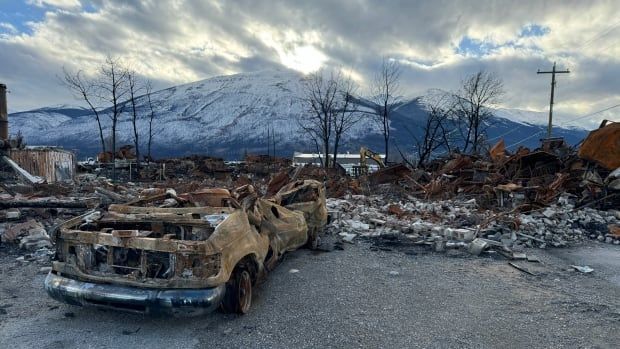 A burned car and building in Jasper, Alberta.