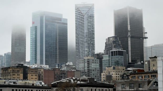 Fog hangs over the skyline of Montreal, Wednesday, Jan. 1, 2025. 