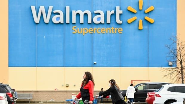 People leave the Walmart after shopping during the COVID-19 pandemic in Mississauga, Ont., Thursday, Nov. 26, 2020.