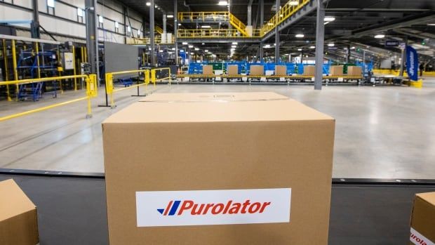 A box with a 'Purolator' logo on it sits in the foreground, as a large shipping facility is pictured behind it.