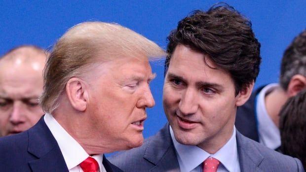 A pugnacious Donald Trump, his jaw thrust forward, talks to Justin Trudeau, whose head is tilted with a quizzical expression.