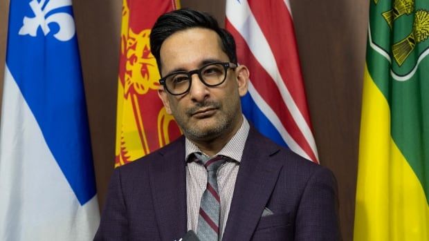 Former Canadian Human Rights chief commissioner Birju Dattani listens to his lawyer during a news conference on Parliament hill, Thursday, Feb. 6, 2025 in Ottawa.  