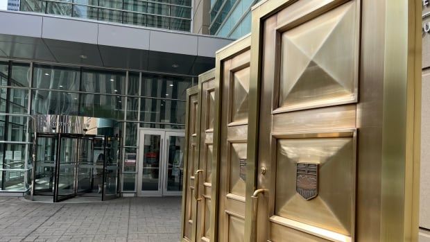 Gold doors and a glass building. 