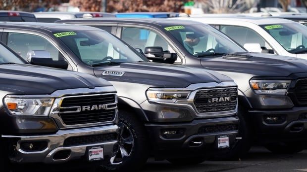 Pickup trucks sit at a dealership