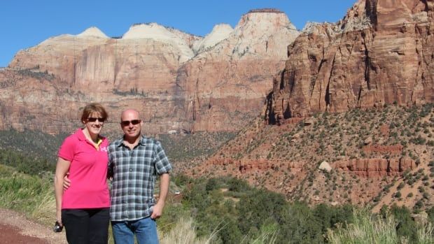 A woman and man are shown in front of canyons.