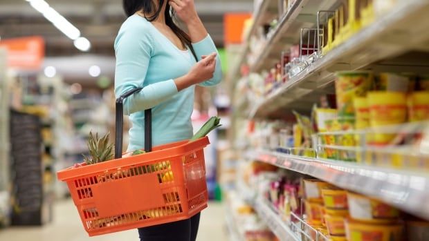 Stock image of a woman grocery shopping.