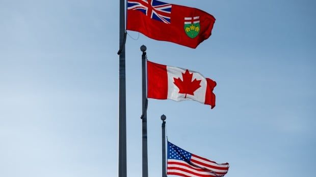 The Ontario, Canadian and U.S. flags are seen at the Canada Border Services Agency Lansdowne port of entry in Lansdowne, Ont., on Feb. 12, 2025.