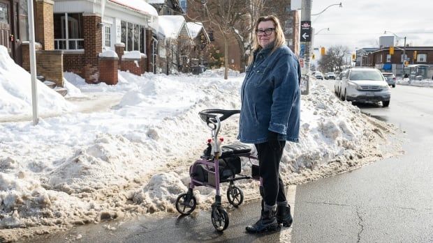 Liisa Nisula, an East York resident, struggles with snow-covered sidewalks in the Danforth-Coxwell area in Toronto, Thursday, February 20, 2025. THE CANADIAN PRESS/Eduardo Lima