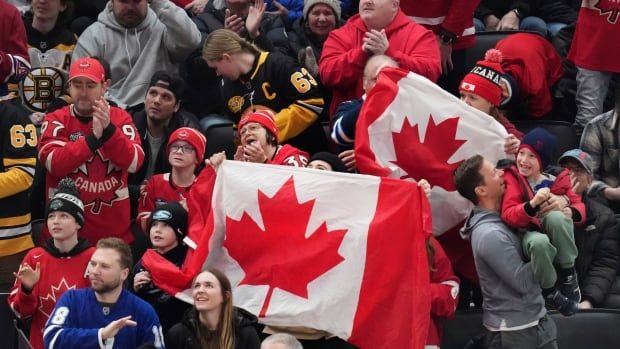 Fans wave Canadian flags.