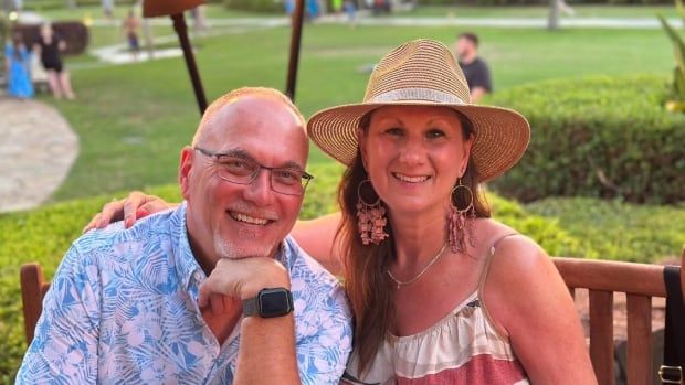 A man and a woman sitting outdoors