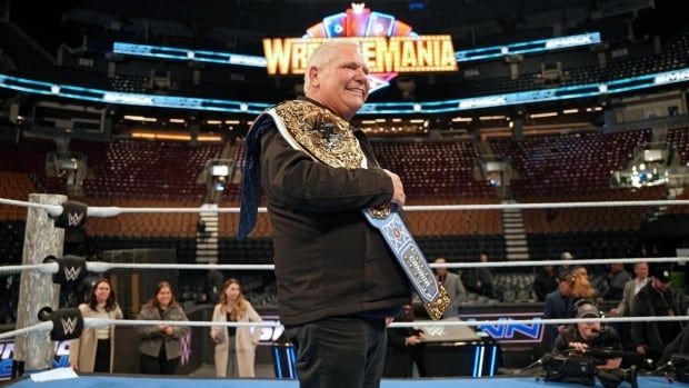 A man with a wrestling belt.