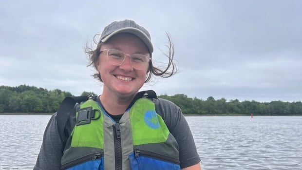 Sarah Cusack sits in a boat wearing a lifejacket.