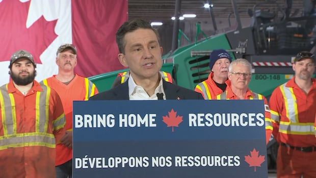 Pierre Poilievre at a podium with worker behind him 