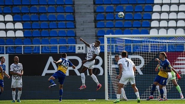 Christian Bilovar of Dynamo Kyiv watches as Benito of Zorya Luhansk, middle, clears the ball during a Ukraine Premier League match in Kyiv, Ukraine 