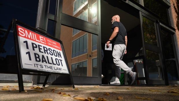 A voter enters the Bucks County Administration building in Doylestown, Pa.