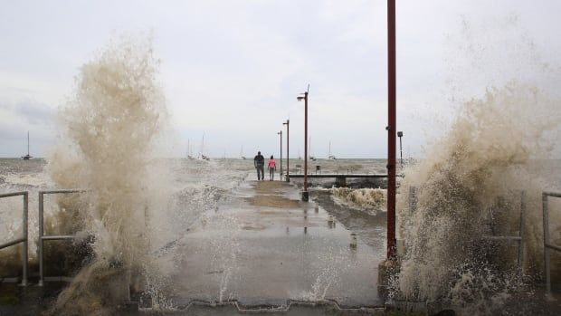 Waves crash into a pier after Hurricane Beryl made landfall in Trinidad and Tobago in July. Beryl made history as the earliest Category 5 storm to ever form in the Caribbean. 