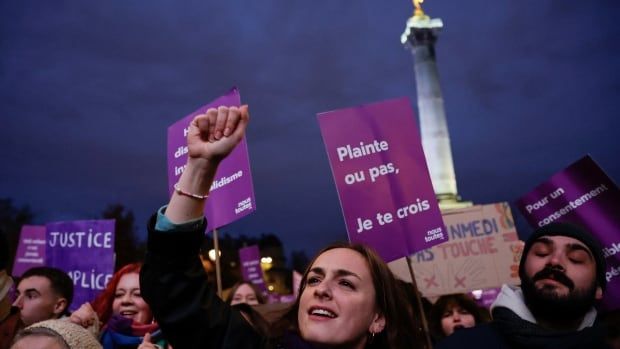 A person gestures, as people attend a demonstration to protest against femicide in Paris.