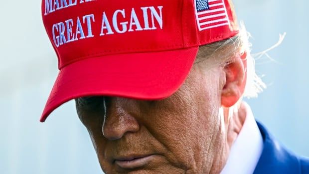 U.S. president-elect Donald Trump is seen wearing a hat labelled 'Make America Great Again,' during a visit to Boca Chica, Texas.