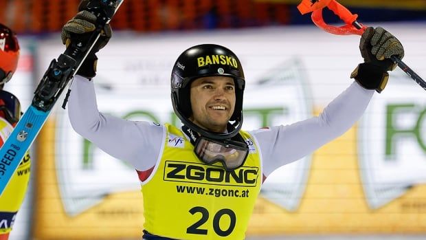 Bulgarian athlete Albert Popov raises his arms, a ski in his right hand and a pole in his left, after his victory in a World Cup men's slalom on January 8, 2025 in Madonna di Campiglio, Italy.